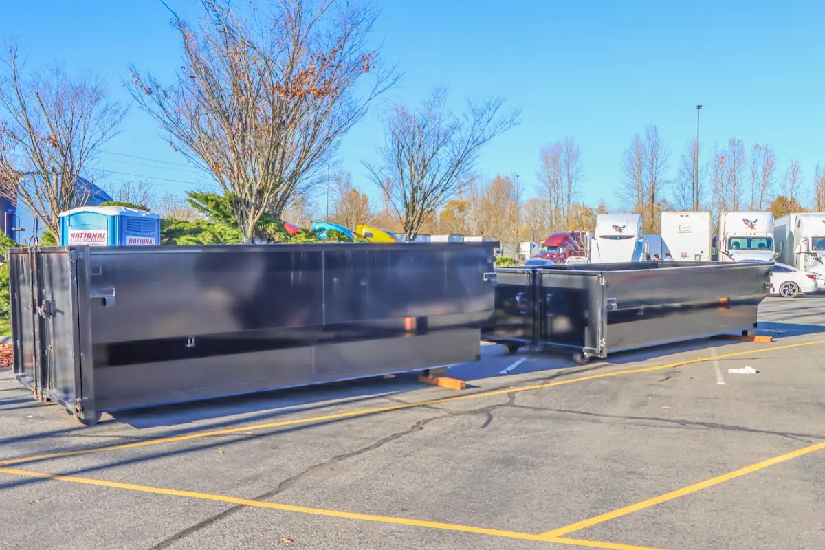 Professional dumpster rental service with roll-off container on residential driveway in Wheelersburg